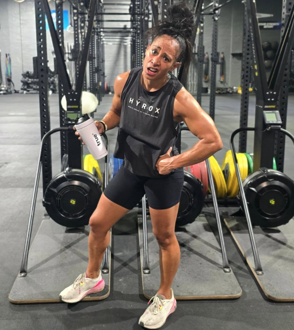 Women at Gym with True protein shaker and hyrox shirt